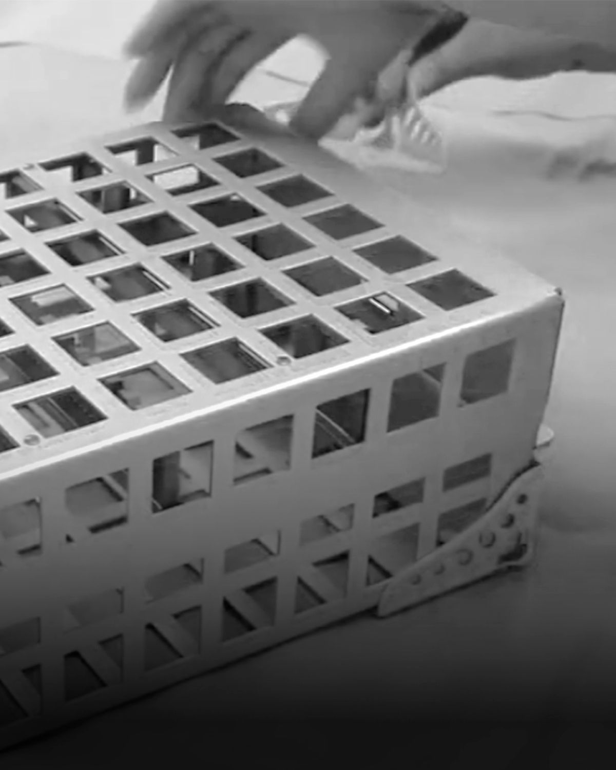 Healthcare worker operating a medical device on a patient's arm.