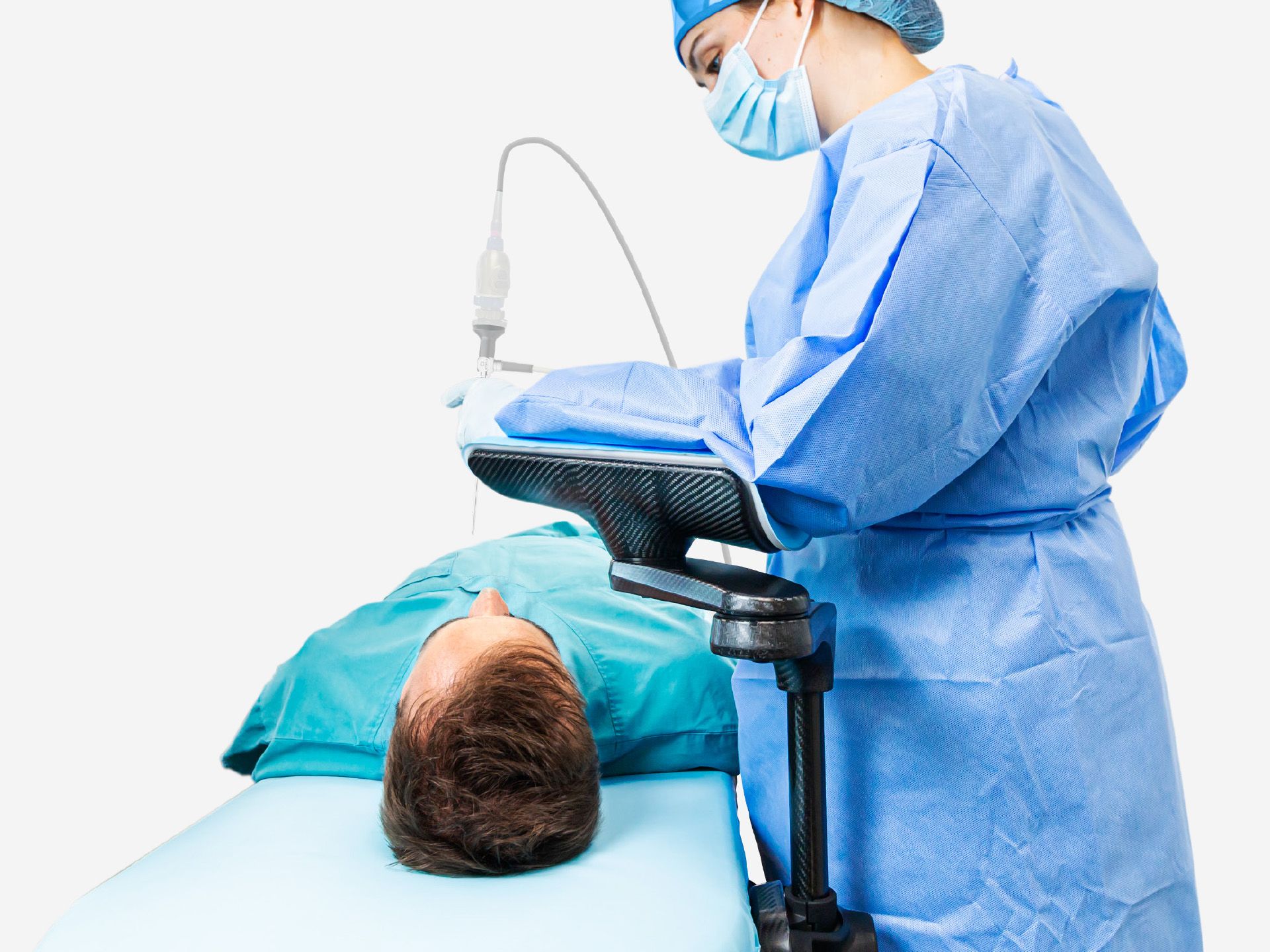 A medical professional in surgical attire uses a medical imaging device on a patient's head.