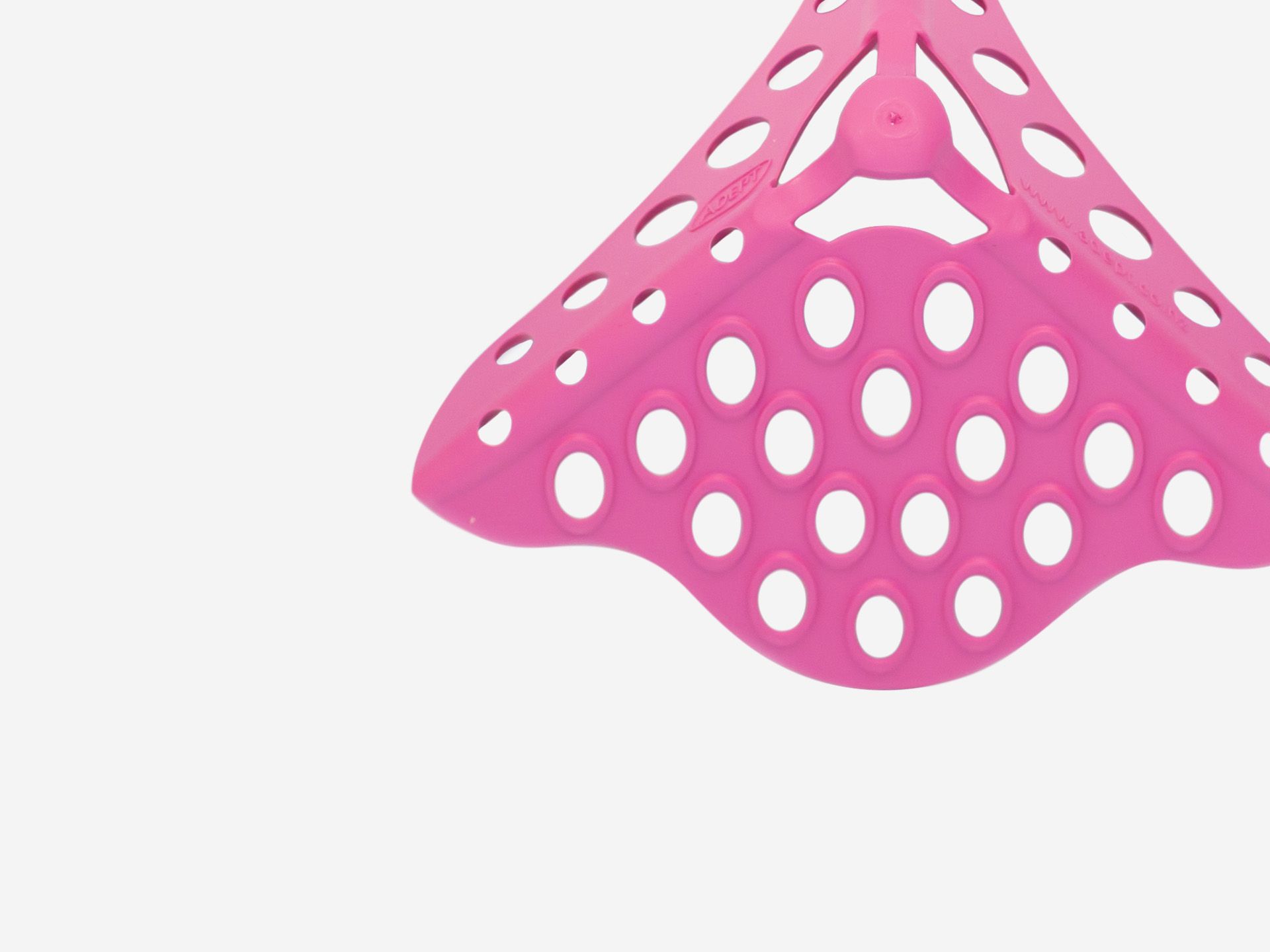 A pink perforated triangular corner mat.